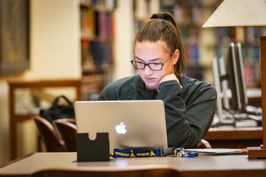 A WVU student enjoys the resources and quiet of the WV Collection downtown library for study and research May 2, 2018. Photo Greg Ellis